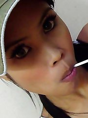 Hot THai babe named Ni licks and sucks a lolipop to tease us