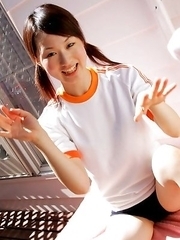 Naoko Sawano in sports outfit plays with balls in garden